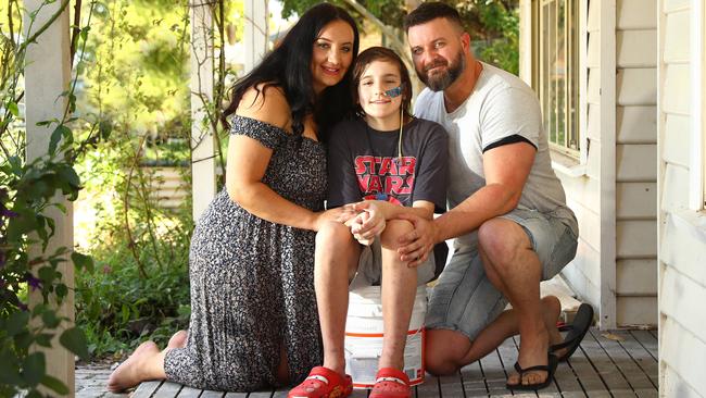 Seb Bridge with his parents Janelle and Daniel at their house which is currently being replastered. Picture: Alison Wynd