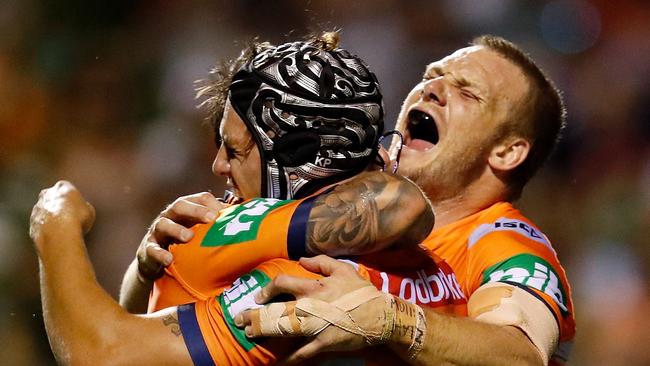 TAMWORTH, AUSTRALIA — APRIL 21: Mitchell Pearce of the Knights celebrates with Kalyn Ponga and Nathan Ross after scoring a try during the round seven NRL match between the Wests Tigers and the Newcastle Knights at Scully Park on April 21, 2018 in Tamworth, Australia. (Photo by Jason McCawley/Getty Images)