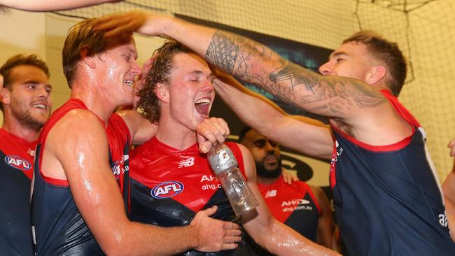 Josh Wagner and Jayden Hunt of the Demons are congratulated by Dean Kent as the Demons celebrate winning. Picture: Quinn Rooney/Getty Images)