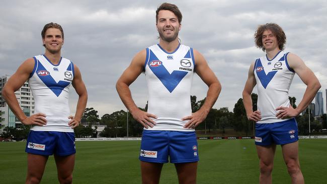 North Melbourne players Mason Wood, Luke McDonald and Ben Brown modelling the club’s 2018 preseason guernsey. Picture: Michael Klein