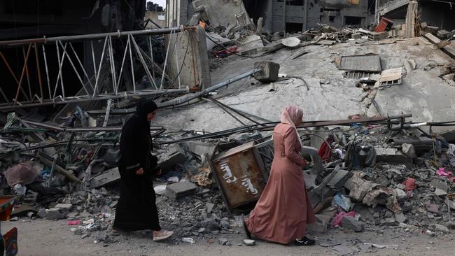 Women walk past a destroyed building in the aftermath of Israeli bombing in Rafah in October 28. Picture: AFP
