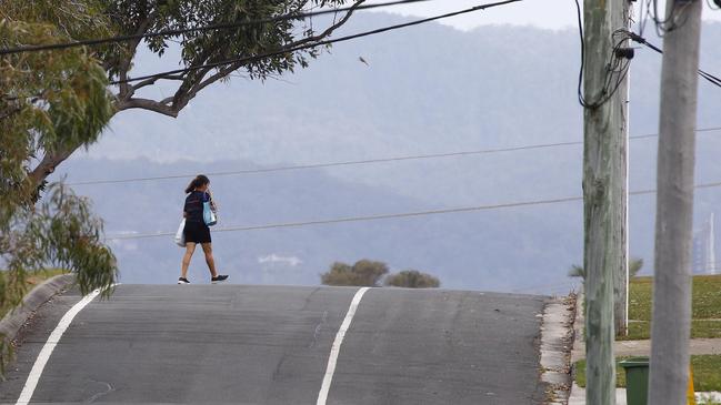 Pedestrians walk in the road on Coolibah street in Southport. Picture: Tertius Pickard