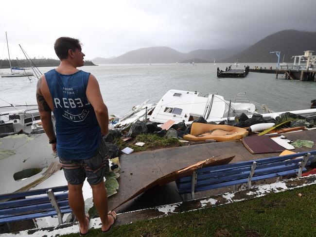 Locals inspect damage at Shute Harbour, Airlie Beach, Wednesday, March 29, 2017. Picture: AAP Image/Dan Peled