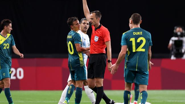 SAPPORO, JAPAN - JULY 22: Denis Genreau #10 of Team Australia is shown a yellow card by Match Referee, Srdan Jovanovic during the Men's First Round Group C match between Argentina and Australia during the Tokyo 2020 Olympic Games at Sapporo Dome on July 22, 2021 in Sapporo, Hokkaido, Japan. (Photo by Masashi Hara/Getty Images)