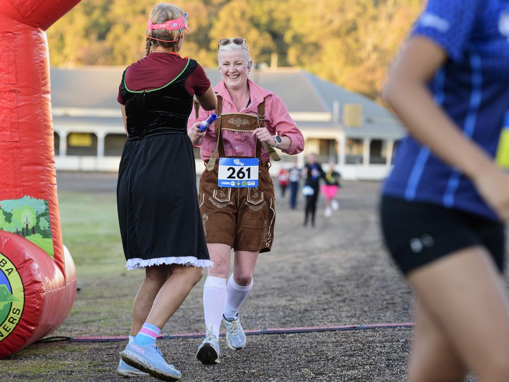 Kirsten Douglas-Robinson passes the baton to Kristen Knight for team Sole Mates and Stein Dates in the 40 for Fortey relay at Toowoomba Showgrounds, Sunday, June 8, 2025. Picture: Kevin Farmer