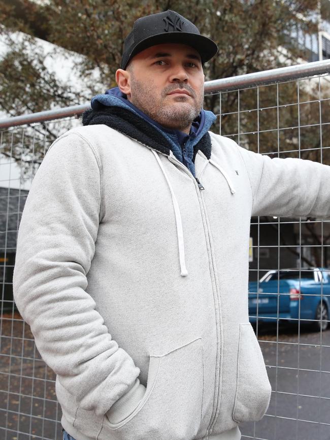 Fabiano Santos was among several residents escorted back in to the Mascot Towers to collect belongings. Picture: David Swift