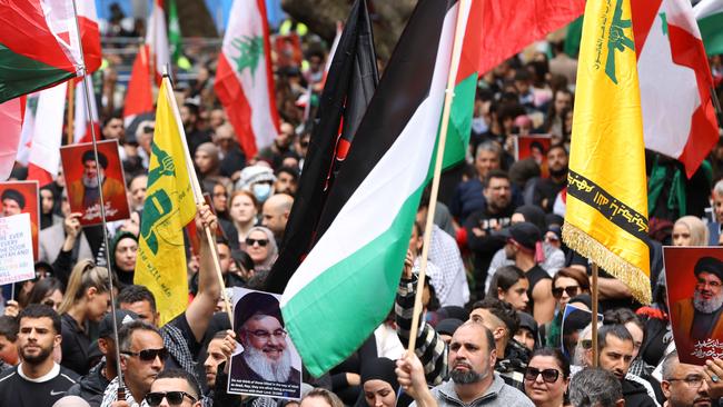 Some protesters held the yellow Hezbollah flag at a rally in Sydney, although police have confirmed displaying a symbol may not constitute an offence on its own. Picture: NewsWire / Damian Shaw