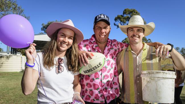 Getting ready for the miniature pig races are (from left) Sadie’s aunty Anthea Beveridge, uncle Cam Moodie and Zac Beveridge at Sadie's Day Out, a special community event to celebrate the life of five-year-old crash victim Sadie, held at Cambooya State School, Saturday, June 7, 2025. Picture: Kevin Farmer