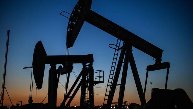 Oil pumpjacks operate at dusk at Willow Springs Park in Long Beach, California. Picture: AFP