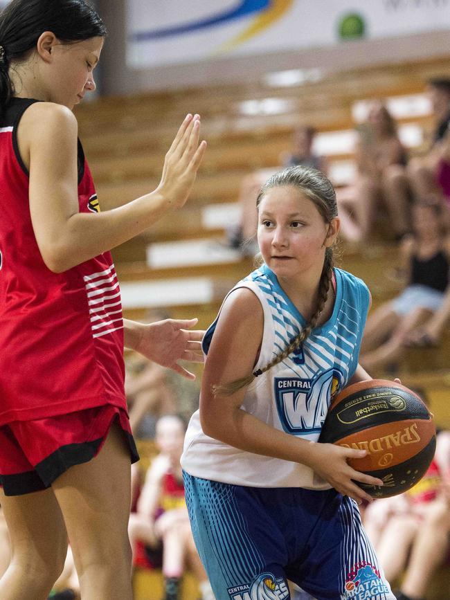 Central Coast Waves player Izzy Gilham tries to get past Gosford City Rebels player Kylah Maley during the under-14 women’s basketball playoff at Breakers Indoor Sports Stadium, Terrigal, on Sunday, 2 February, 2020. Picture: Troy Snook