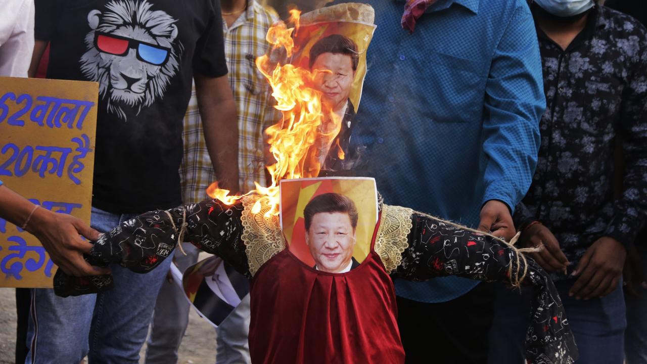 As well as being accused of launching technological wars in Australia, China has started a physical attack in India, killing 20 Indian troops yesterday. This picture shows Indians burning an effigy of Chinese President Xi Jinping after the attack Picture: Ajit Solanki/AP