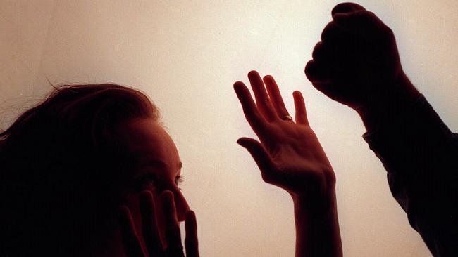 Domestic violence silhouette generic image – fist raised against woman./Violence