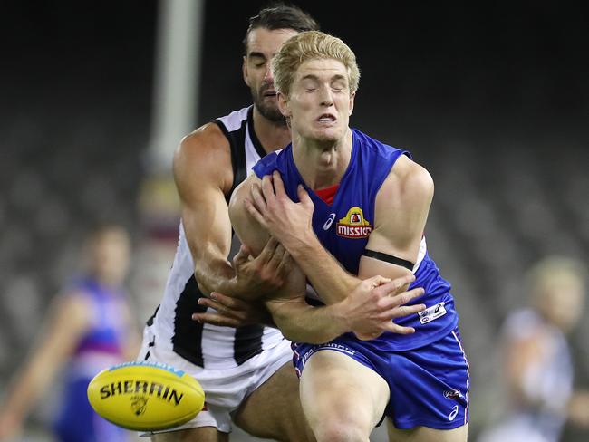 Tim English was taught a football lesson by Brodie Grundy. Picture: Michael Klein