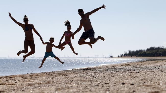 Kirsty Stewart, Nixon (5), Tayla (8) and Wayne Stewart posing at the Wellington Point Recreation Reserve next to King Island. (AAP Image/Josh Woning)