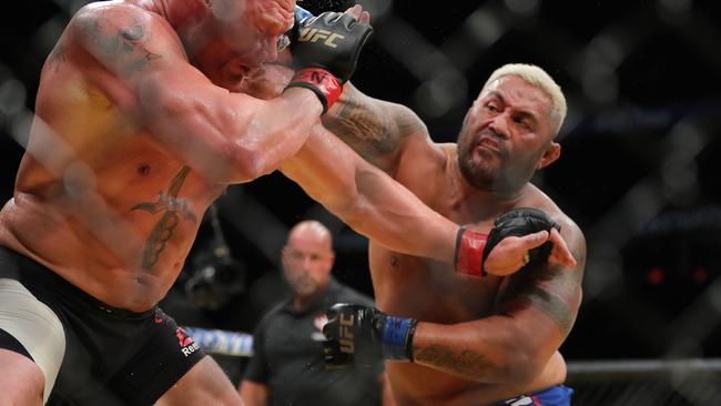 Mark Hunt punches Brock Lesnar during UFC 200.