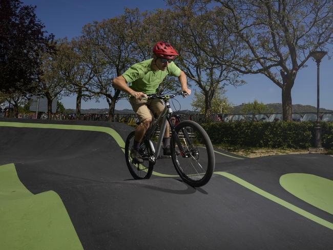 Cyclist on a pump track circuit passing through a boost zone