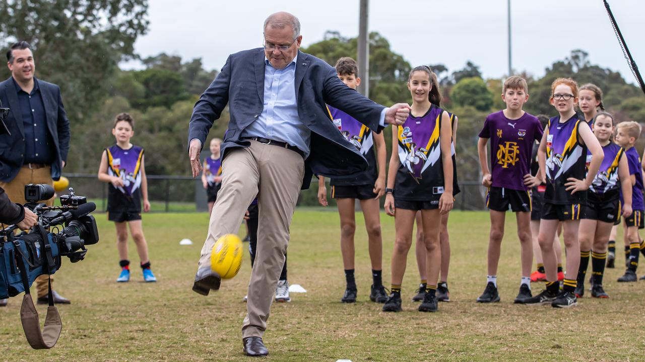 Prime Minister Scott Morrison visits Norwood Sporting Club in Ringwood, Victoria and attempts to kick the Sherrin. Picture: Jason Edwards