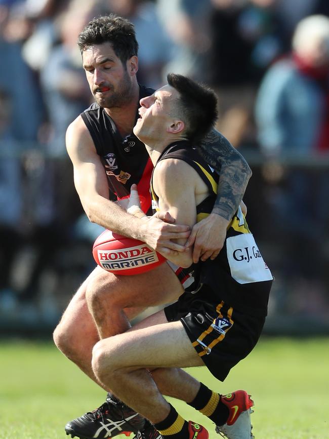 Boisdale-Briagolong coach Sam Bedggood tackles Wy Yung’s Luke Elia.