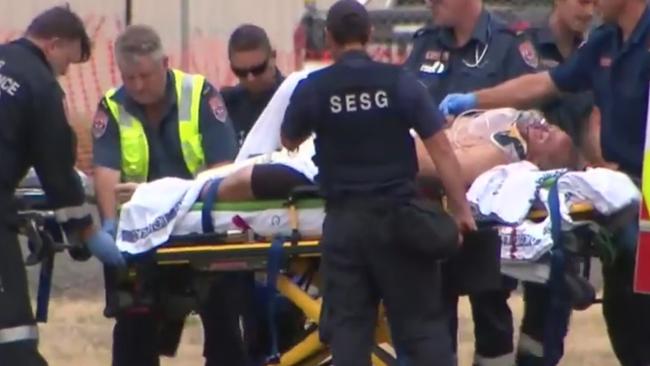 Paramedics frantically work on a man at the prison. Picture: Nine News