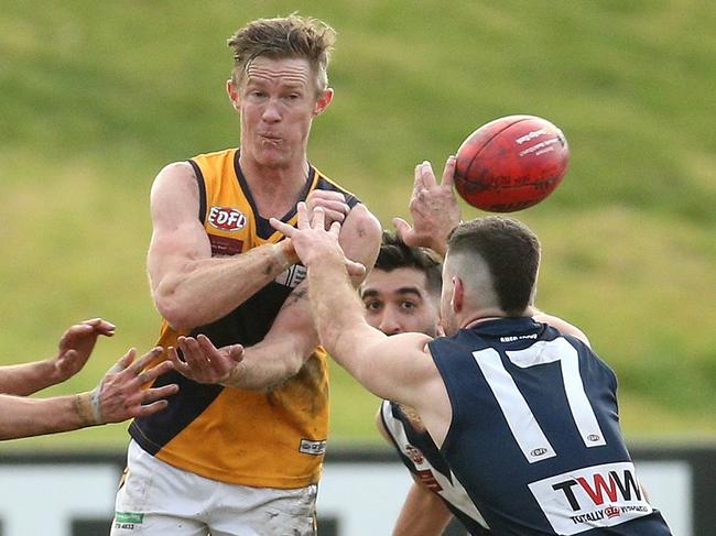 EDFL footy: Avondale Heights v Strathmore: Luke Jarrad of Strathmore handpasses under pressureSaturday, June 19, 2021, in Avondale Heights, Victoria, Australia. Picture: Hamish Blair