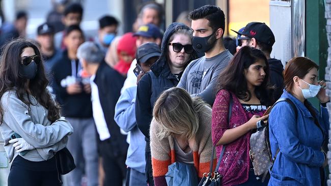 People queue to enter Centrelink in Melbourne in March. Picture: Quinn Rooney/Getty Images.