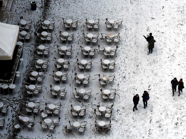 Aerial view of people walking on the snow-covered St Mark’s square in Venice on February 28, 2018 after a overnigth snowfall. Picture: AFP