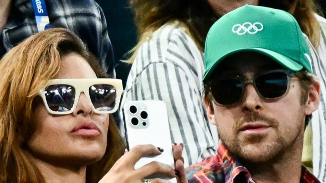 US actress Eva Mendes (L) and her partner Canadian actor Ryan Gosling (R) attend the artistic gymnastics women's uneven bars final during the Paris 2024 Olympic Games at the Bercy Arena in Paris, on August 4, 2024. (Photo by Loic VENANCE / AFP)