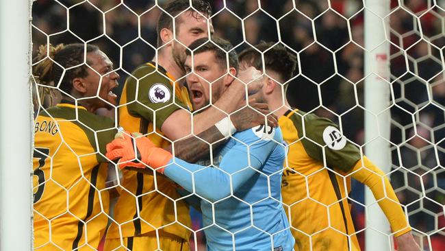 Mathew Ryan of Brighton and Hove Albion celebrates with teammates after saving a penalty from Charlie Adam
