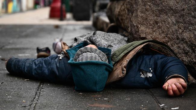 A person lies on the street in the Old Town Chinatown neighbourhood following the decriminalisation of all drugs in downtown Portland, Oregon. Picture: AFP