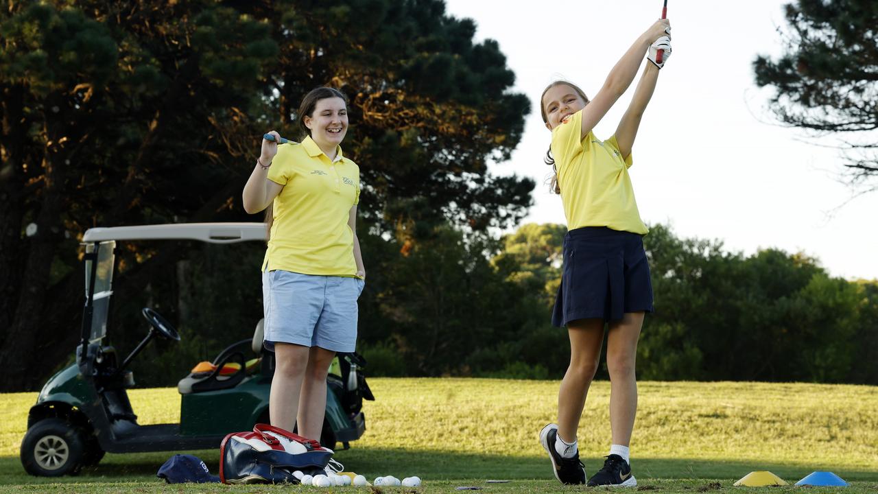 Young golfers Elizabeth Savell, 14, and Eliza Rolfe, 9, during a lesson at East Lakes Golf Club in Pagewood. Picture: Jonathan Ng