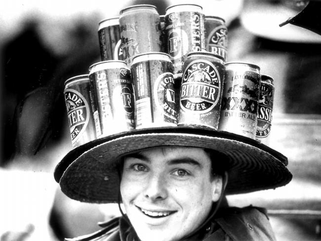 A punter wears a hat adorned with beer cans in 1992.