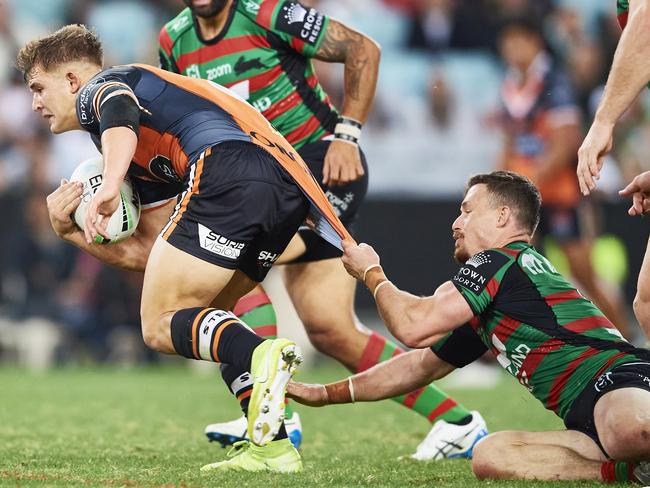 SYDNEY, AUSTRALIA - APRIL 17: Jake Simpkin of the Tigers is tackled  during the round six NRL match between the South Sydney Rabbitohs and the Wests Tigers at Stadium Australia, on April 17, 2021, in Sydney, Australia. (Photo by Brett Hemmings/Getty Images)