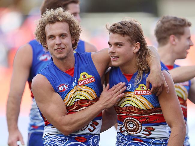 AFL Round 13. Western Bulldogs vs Melbourne at Metricon Stadium, Gold Coast..22/08/2020...  Mitch Wallis and Bailey Smith hug after todays win over melbourne  . Pic: Michael Klein