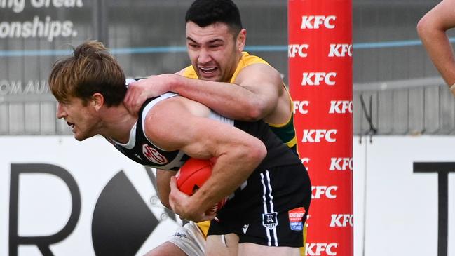 Port Adelaide’s Tom Jonas tries to break away from Woodville-West Torrens’ Connor Ballenden at Alberton Oval. Picture: Naomi Jellicoe