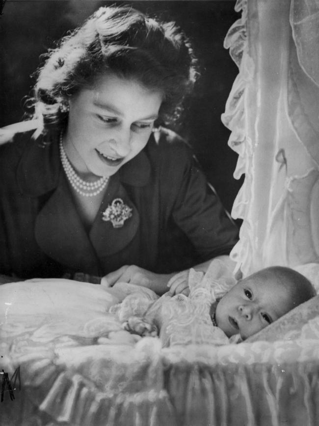 Princess Elizabeth (later Queen Elizabeth II) with Charles in his cradle. Picture: Supplied