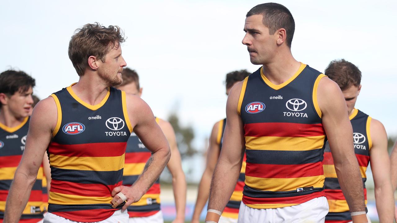 Rory Sloane (left) believes Taylor Walker will slot back in to the Crows seamlessly. (Photo by Morgan Hancock/Getty Images)