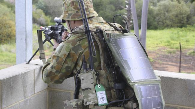 Heavy battery packs replaced ... An Australian soldier wears flexible solar panels instead. Picture: ADF