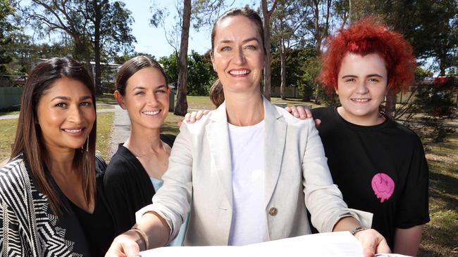 Queensland State Manager Antoinette Rusby-Perera, Kloe, 28, The Lady Musgrave Trust CEO Victoria Parker, and Lauren, 21, looking over the new housing project plans in Logan. Picture: Liam Kidston