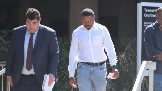 Sean Ladi Suk (right), 22, leaves court after being sentenced for seven counts of stalking.