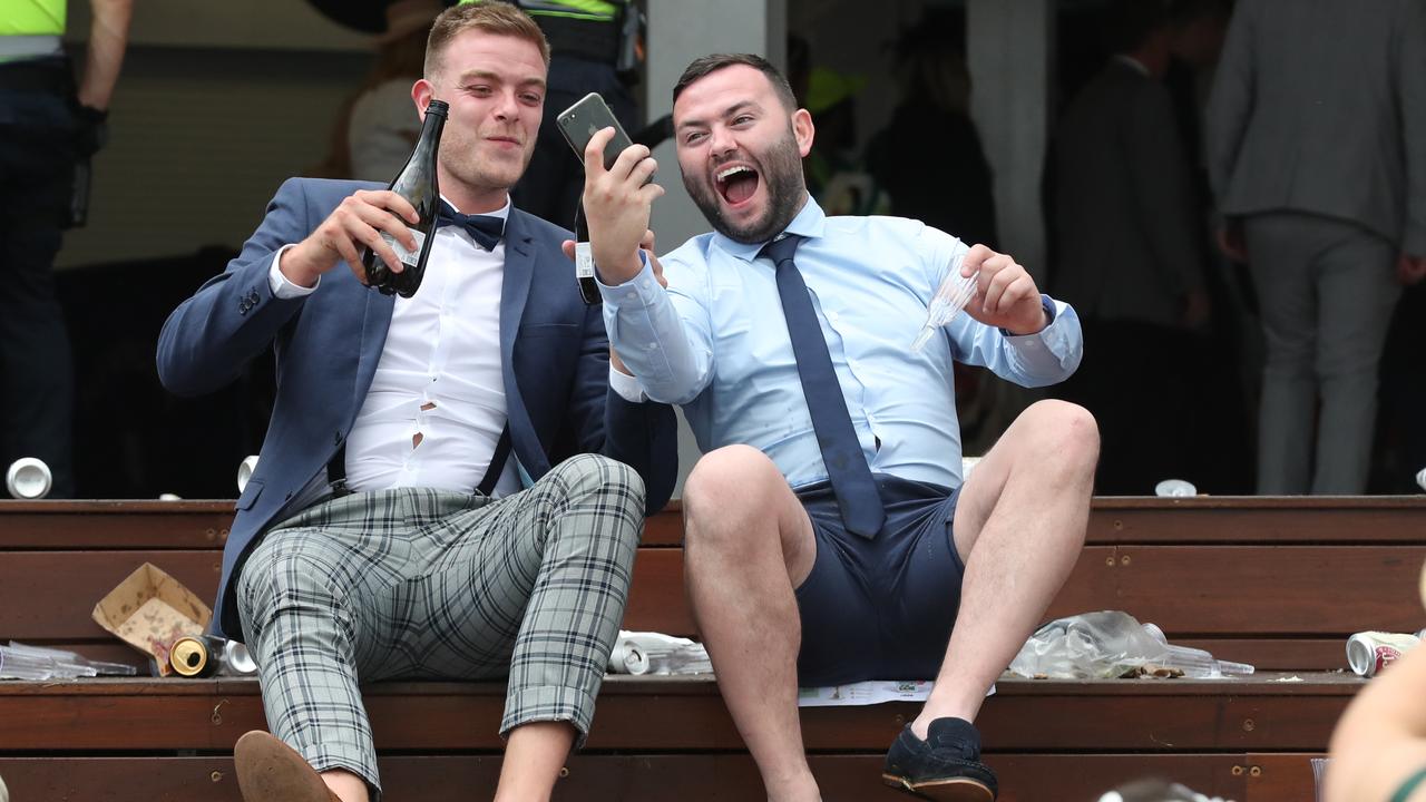 Racegoers didn’t let the rain dampen their spirits. Picture: Dave Crosling/AAP