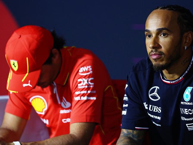 BAHRAIN, BAHRAIN - FEBRUARY 28: Carlos Sainz of Spain and Ferrari and Lewis Hamilton of Great Britain and Mercedes attend the Drivers Press Conference during previews ahead of the F1 Grand Prix of Bahrain at Bahrain International Circuit on February 28, 2024 in Bahrain, Bahrain. (Photo by Clive Rose/Getty Images)