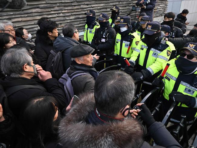 Protesters are blocked by police as they try to walk through a street. Picture: AFP