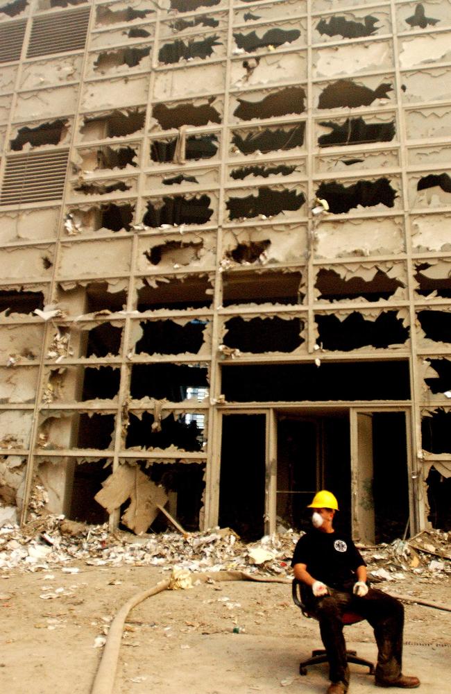 A rescuer on a break surrounded by the eerie reminder of what once was a bustling area of world commerce. Picture: Alamy