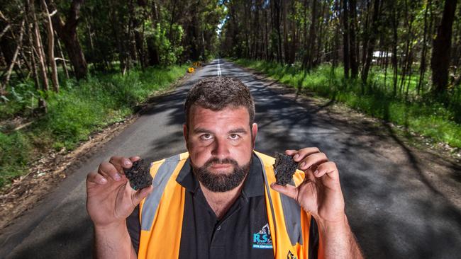 Truck driver Adam Slater shows the condition of the Colac-Forrest Road. Picture: Tony Gough