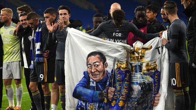 Leicester players unveil a banner honouring their late owner. Picture: AFP.