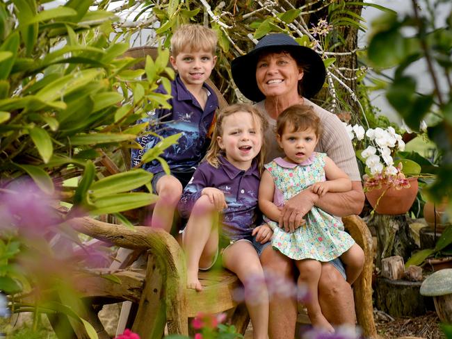 Natalie Pace, with grandchildren Fletcher Marshall, 5, Elise Marshall, 3, and Georgia Pace, 18 months, is opening her Rollingstone garden up to the public this Saturday to support a childrens' cancer charity. Picture: Evan Morgan