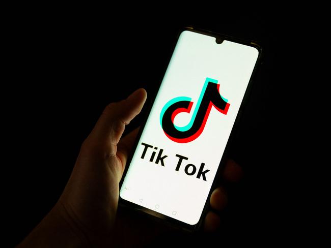 (FILES) This photograph taken on April 19, 2024 shows a man holding a smartphone displaying the logo of Chinese social media platform Tiktok in an office in Paris. Albanian Prime Minister Edi Rama announced on December 21, 2024, that the government will shut down social network TikTok for at a least a year starting at the beginning of 2025. (Photo by Antonin UTZ / AFP)