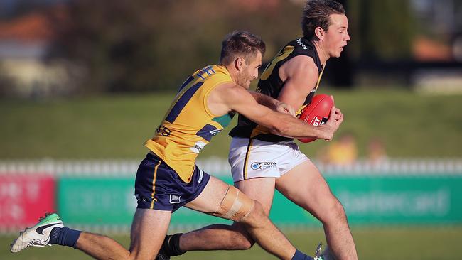 Jarred Allmond tackles Glenelg's Lachlan Earl while playing for the Eagles last year. He is a big pick up for the Roosters in 2018. Picture: Dean Martin