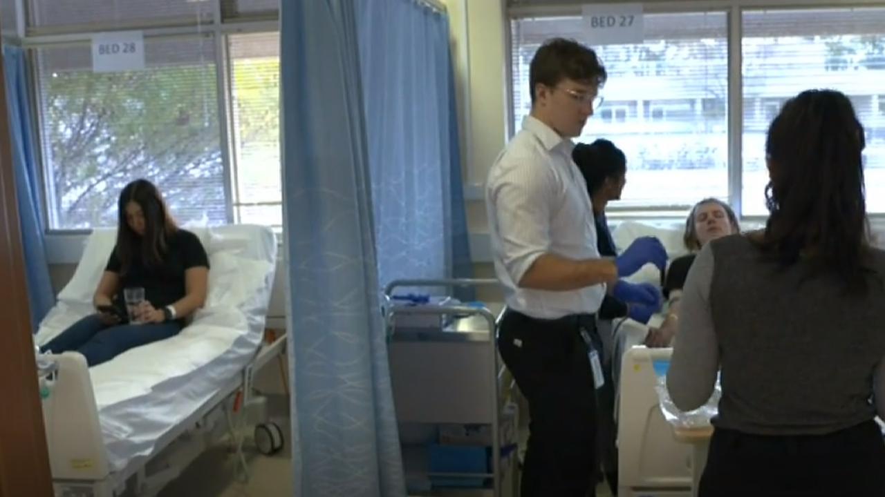 Ms Kalic and Benjamin Bruce get their first injection. Picture: 7.30