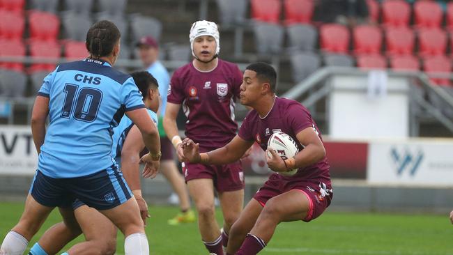 Action from the Australian state schools national rugby league championship match between Queensland Maroon and NSW CHS. QLDÃ&#149;S Mace Andrew attacks. Picture: Tertius Pickard